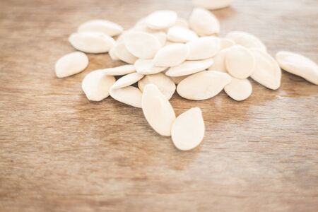 Pumpkin seeds on weathered woodの写真素材