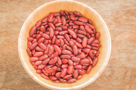 Raw red kidney bean in wooden bowl