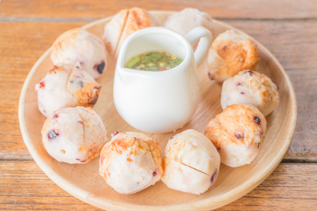 Squid grilled ball on wooden plate, stock photoの写真素材