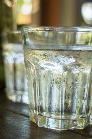 Glass of melt iced water, stock photo
