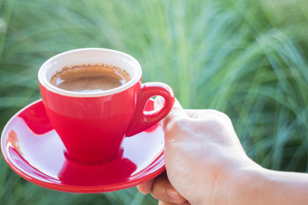 Woman holds a red coffee cup (vintage style color), stock photoの写真素材