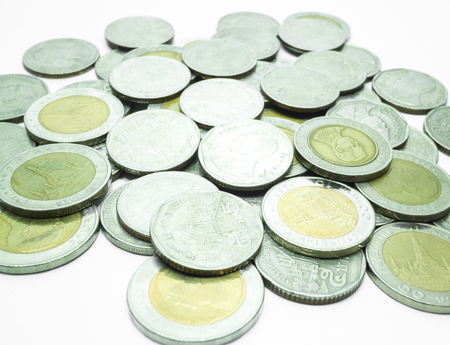 Group of Thai baht coins on white table background, stock photo