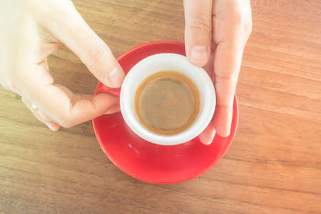 Hands holding cup of hot coffee, stock photoの写真素材