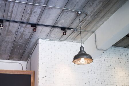 Black ceiling lamp in the room, stock photo