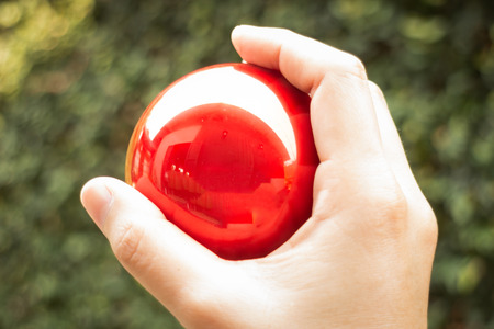 Shiny red ball on hand, stock photoの写真素材