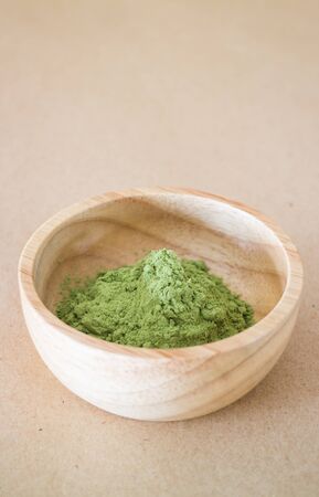 Premium green tea powder in wooden bowl, stock photoの写真素材