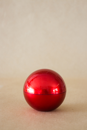 Shiny hard red ball on brown background, stock phoroの写真素材