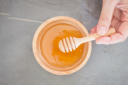 Hand on honey dipper top view, stock photoの写真素材