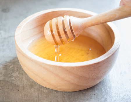 Golden honey cup and dipper, stock photoの写真素材