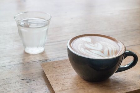 Hot cup of coffee on wooden table, stock photoの写真素材