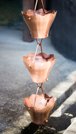 Vintage metallic bells used for rain waters way-out in zen gardenの写真素材