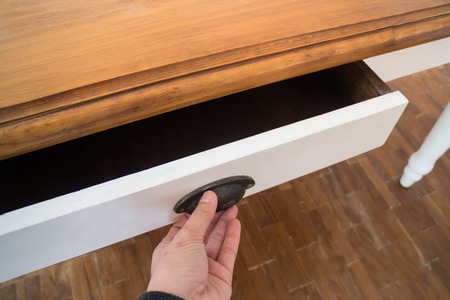 Hand open drawer box of wooden table, stock photoの写真素材