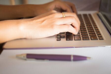 Opened laptop on wooden work table, stock photo