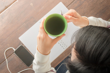 Working creative table and hot green tea drinking, stock photoの写真素材