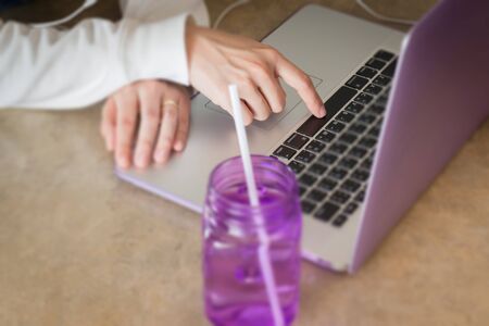 Woman sitting on the floor using laptop, stock photo