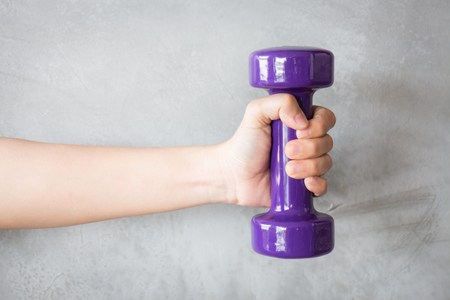 Woman Hand Holding Violet Dumbbell, stock photoの写真素材
