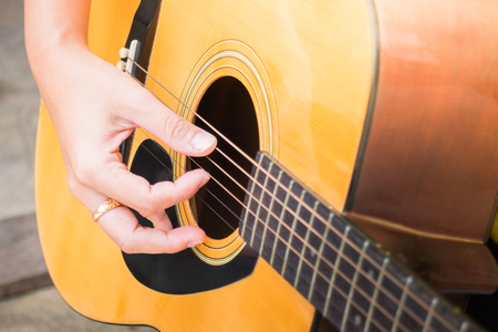 Guitarist Hand Playing Acoustic Guitar, stock photo