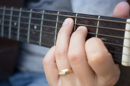 Guitarist Hand Playing Acoustic Guitar, stock photo