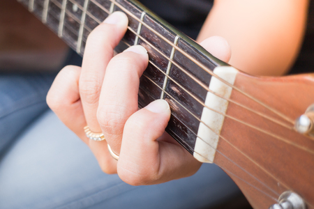 Guitarist Hand Playing Acoustic Guitar, stock photo