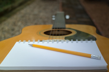 Yellow Acoustic Guitar On Wooden Table, stock photoの写真素材