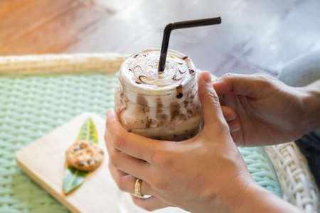 Hand On Iced Chocolate Drink, stock photo