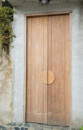 Vintage closed wooden door of house, stock photoの写真素材