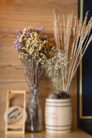 Ornamental basket of wheat on wooden table, stock photoの写真素材