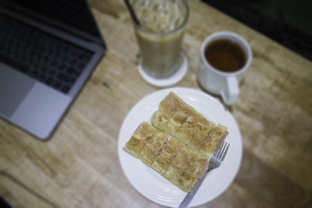 Easy meal in work hour with coffee drink and fried roti, stock photoの写真素材