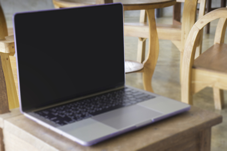 Modern grey metal laptop on wooden table, stock photoの写真素材