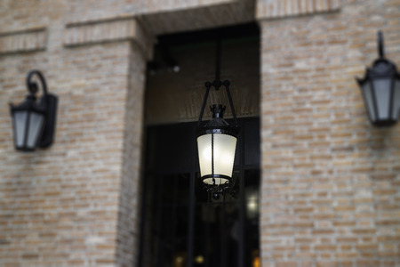 Brick wall building with light lamp, stock photo
