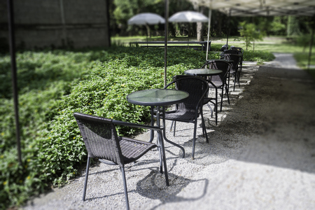 Sidewalk cafe seats in garden.の写真素材