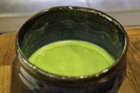Bowl of hot matcha green tea drink, stock photo