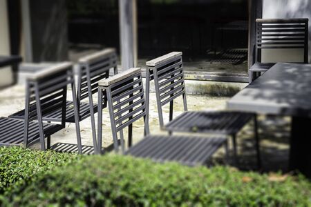 Wooden outdoors seats in summer garden, stock photoの写真素材