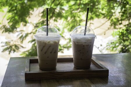 Iced coffee on wooden outdoors table, stock photoの写真素材