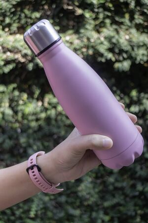 Hand on water bottle for keep temperature, stock photoの写真素材