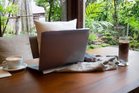 Hot coffee and iced coffee on wooden table, stock photoの写真素材