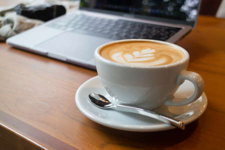 Cup of coffee and laptop on the table, stock photoの写真素材