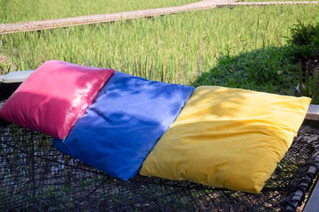 Colorful pillows on net seat among nature, stock photoの写真素材
