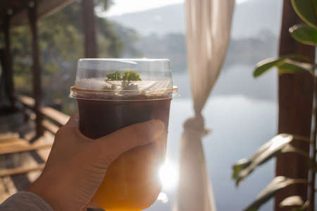 Holding a glass of iced coffee, stock photoの写真素材