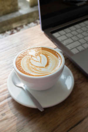 Morning coffee latte on wood desk work from home officeの写真素材