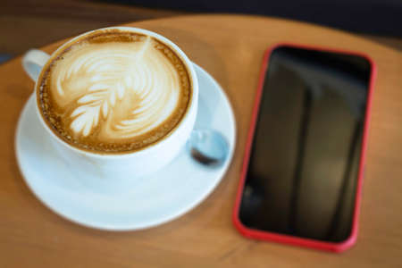 Coffee cup hot latte on wooden table, stock photoの写真素材