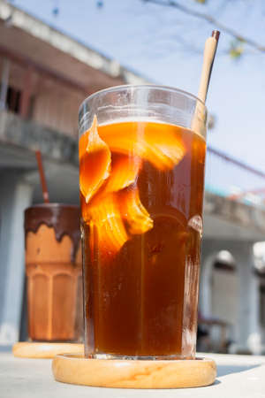 Glass of ice cubes and fresh coffee, stock photo