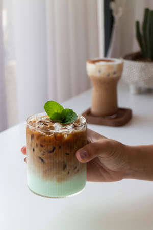 Hand on glass of iced coffee, stock photoの写真素材