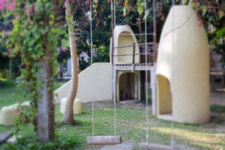 Outdoor playground with green grass ground, stock photo