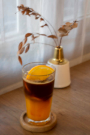 Glass of americano mixed with craft soda and yuzu orange juice blur background, stock photoの写真素材