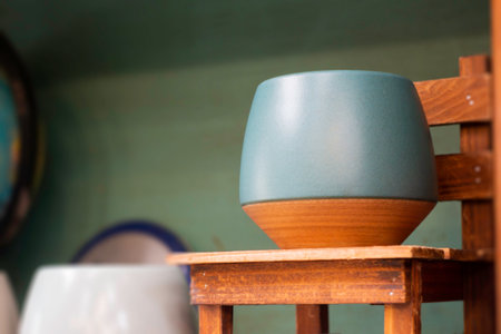 Ceramic vase on wooden shelf in coffee shop or restaurant