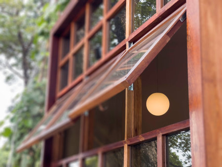 Wooden windows with a light bulb in the middle. Close-up.の写真素材