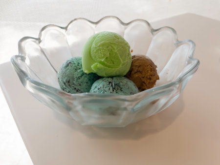 Ice cream scoops in glass bowl, stock photo