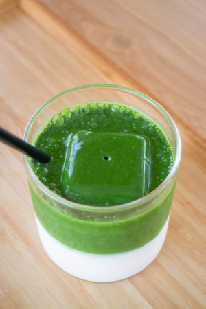 Iced matcha greentea on wooden table, stock photo