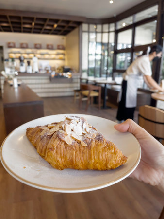 Fresh baked almond croissant and coffee breakfast, stock photoの写真素材